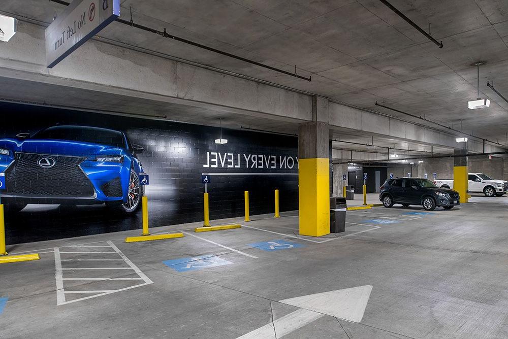 American Airlines Center parking structure in Dallas, TX with bright, high quality lighting from parking garage LED light fixtures in the handicap section.